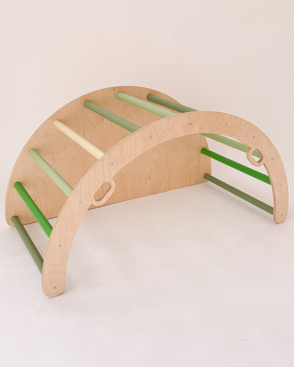 Arco Pikler com lateral fechada a ser usado como baloiço em ambiente interior.